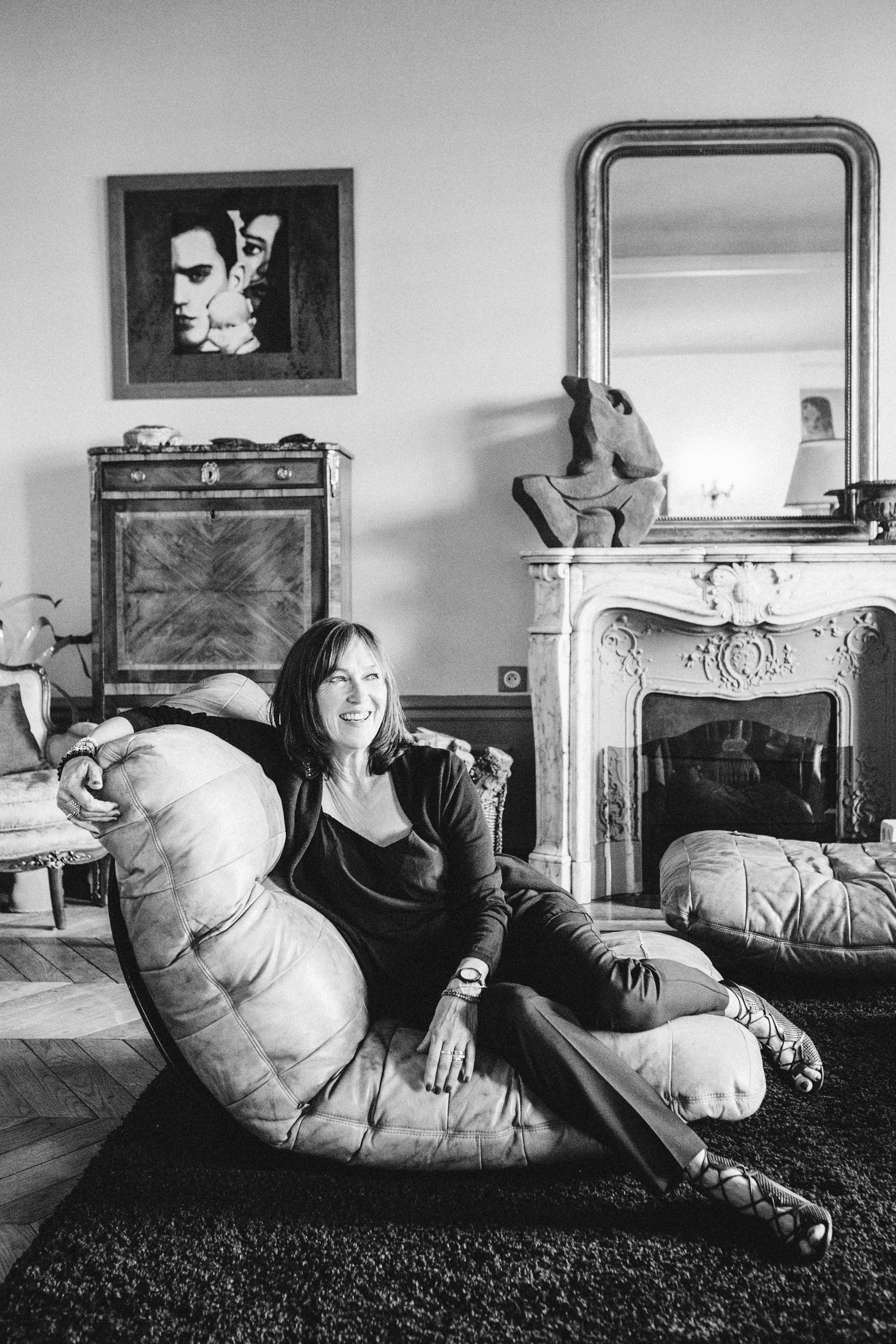 Black and white portrait of a woman in a dimly lit Parisian flat, film noir style photography by Carla Coulson