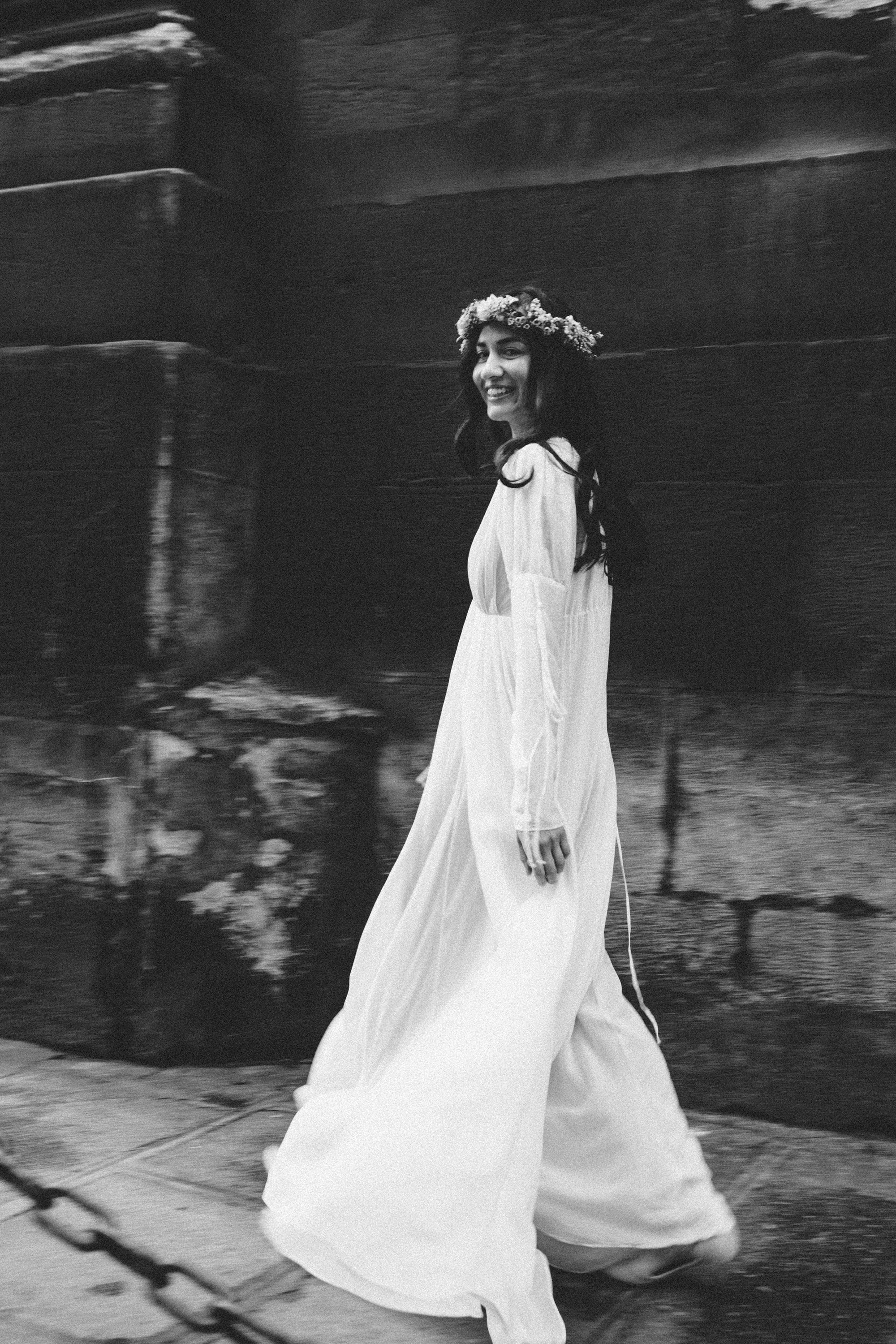 Moody monochrome portrait of a woman in a Parisian sidewalk, film noir style by Carla Coulson
