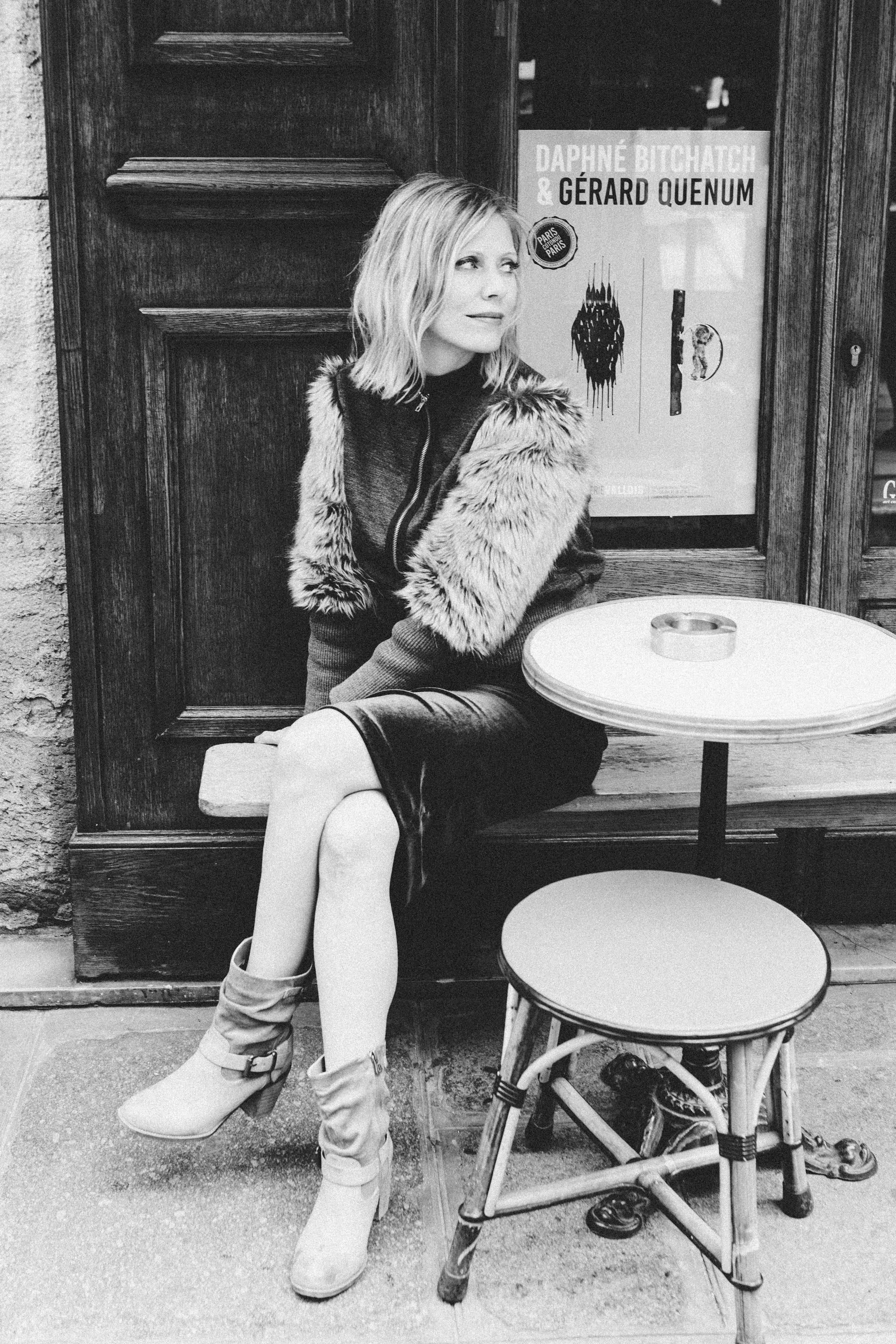 Black and white film noir portrait of a woman in a Parisian setting, photography by Carla Coulson