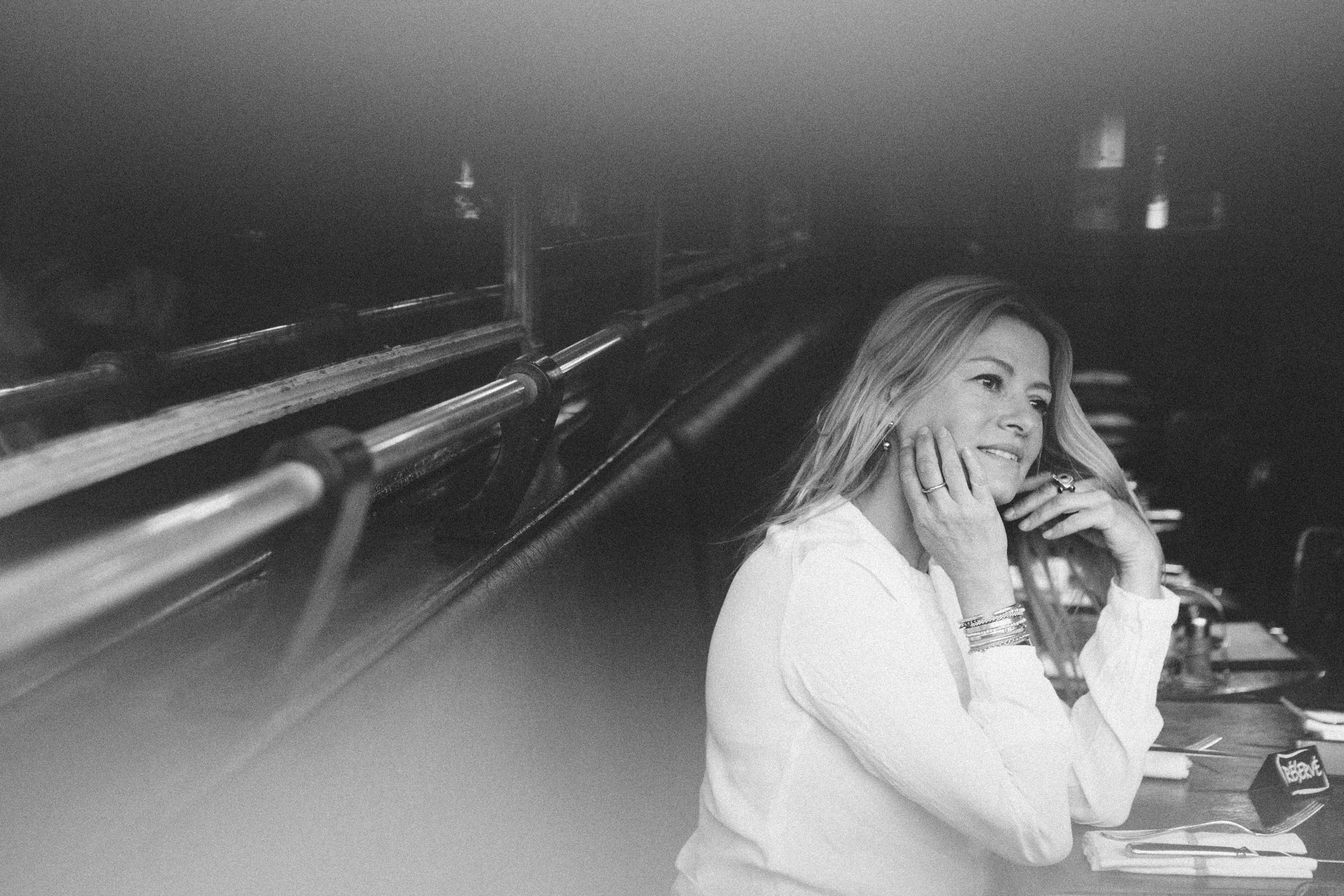 Atmospheric wide-format film noir portrait of a woman in Paris, black and white photography by Carla Coulson