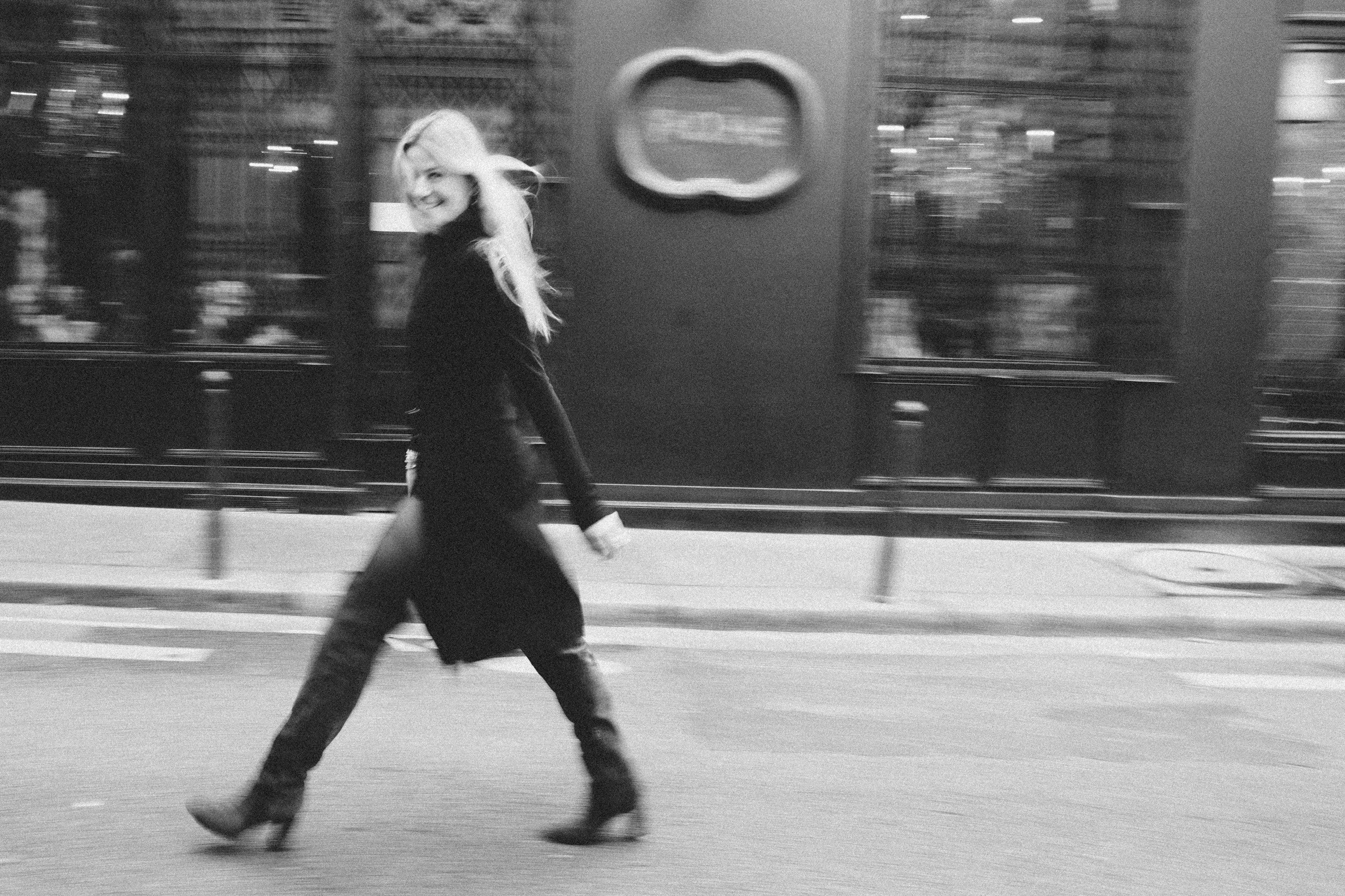 Dramatic film noir portrait of a woman in a Parisian setting, wide monochrome photography by Carla Coulson