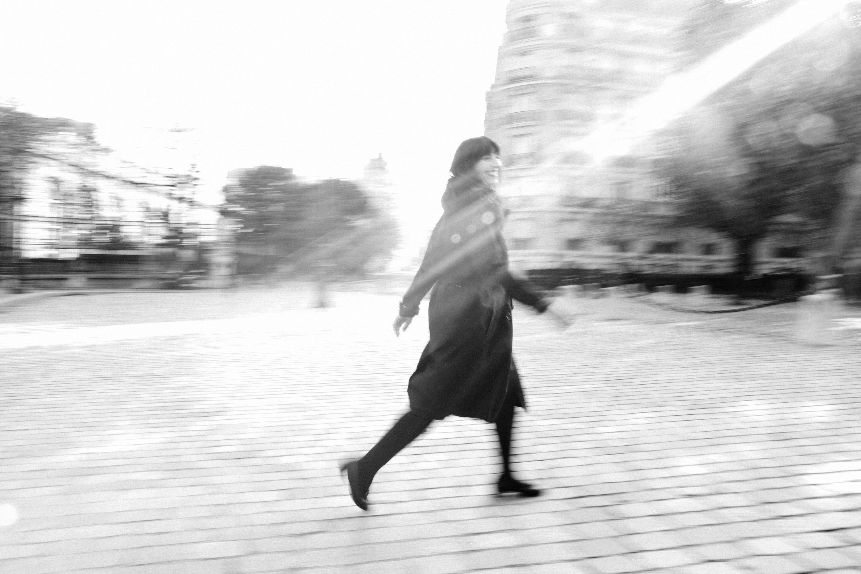 Dramatic wide-format film noir portrait of a woman in Paris, black and white photography by Carla Coulson