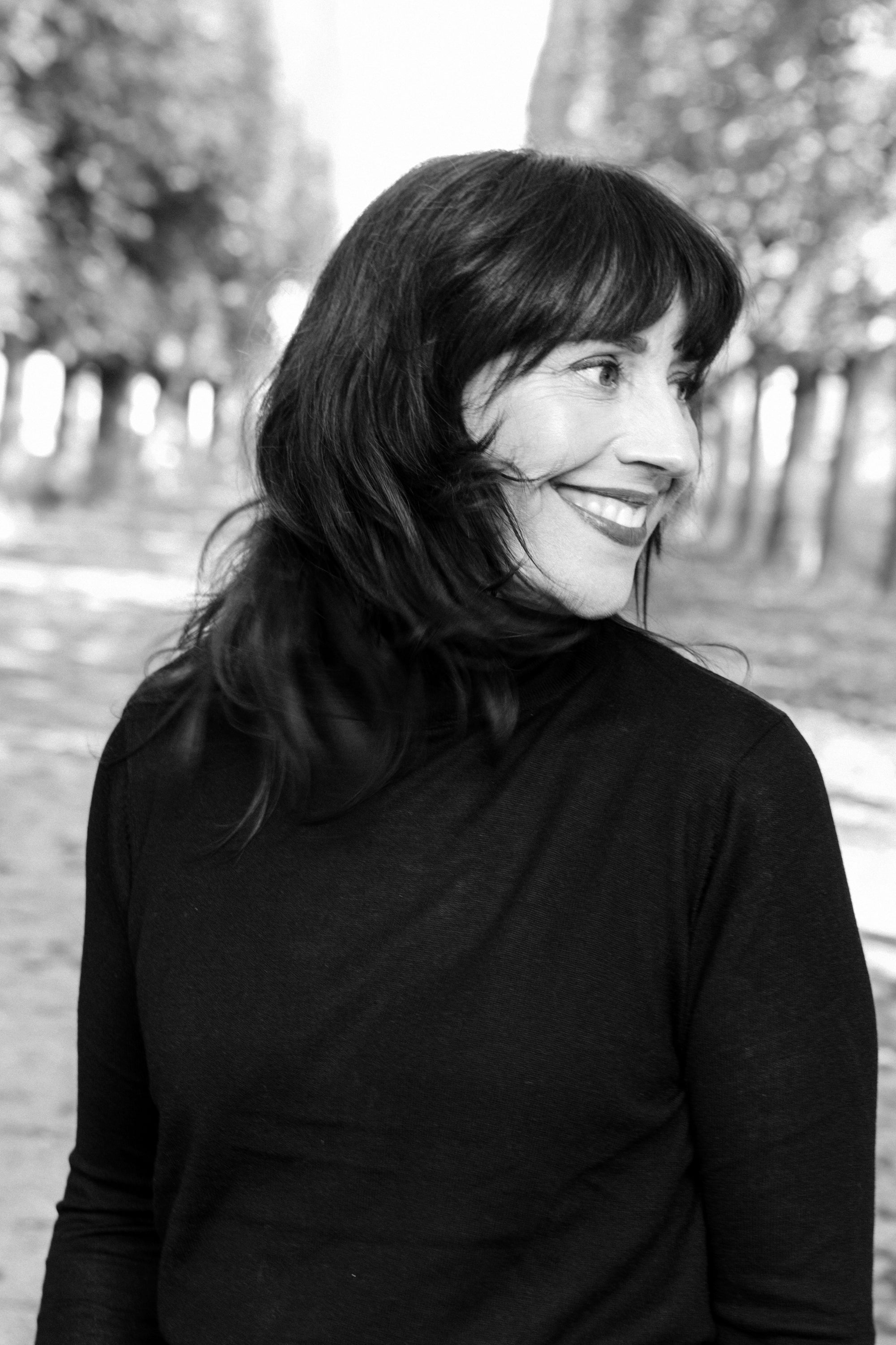 Black and white film noir portrait of a woman in a Paris location, moody photography by Carla Coulson