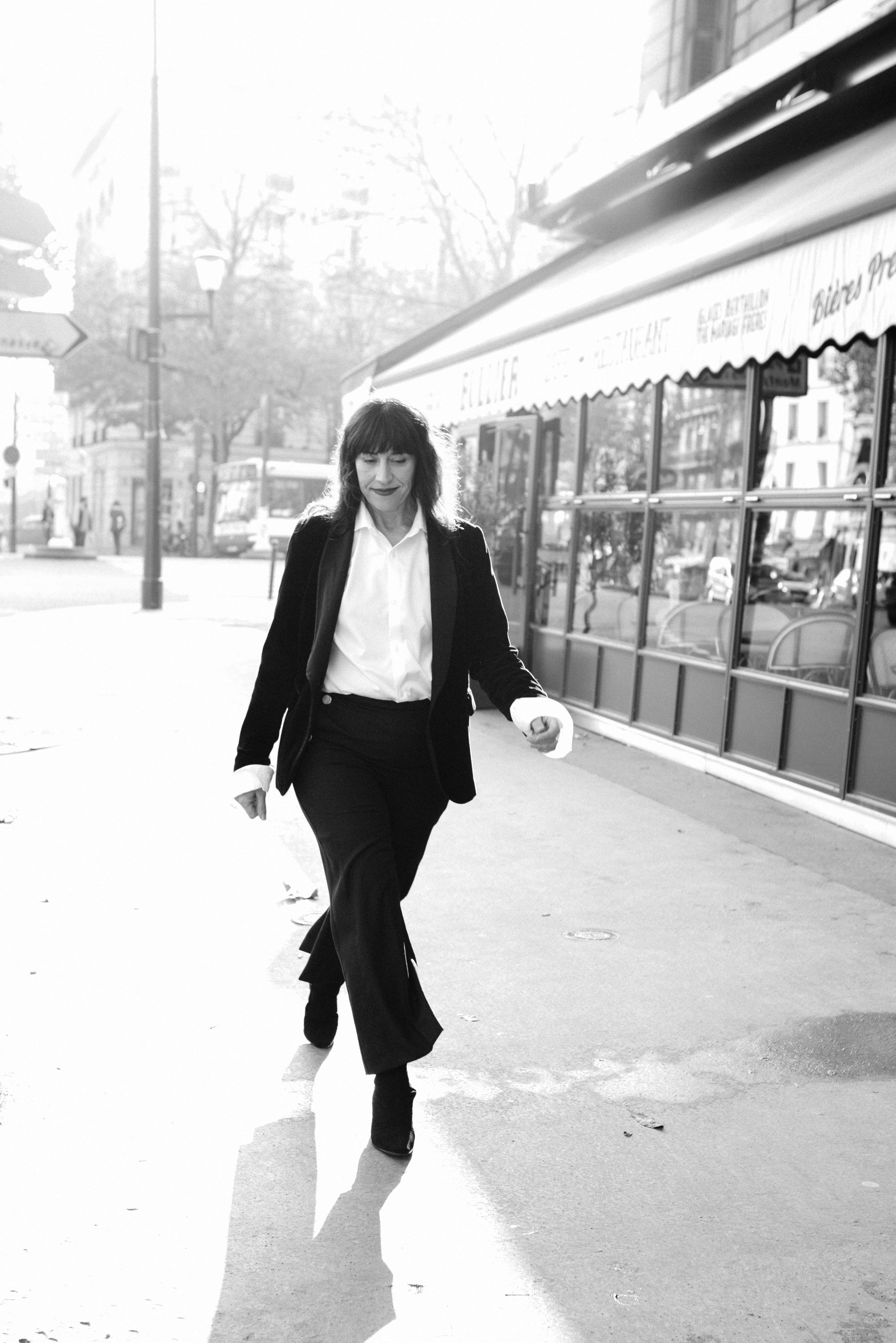 Intimate film noir portrait of a woman in a Parisian setting, monochrome photography by Carla Coulson