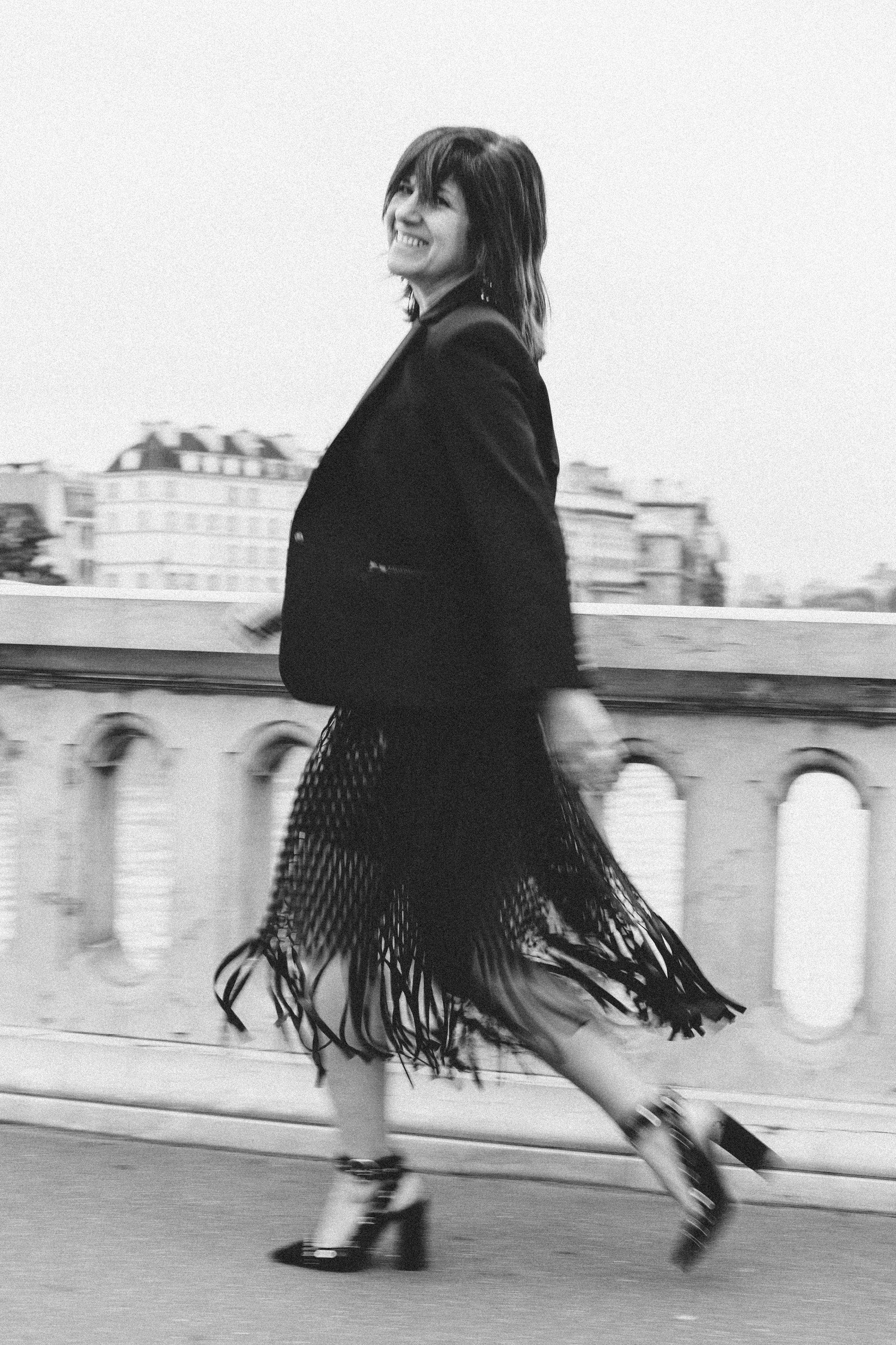 Intimate film noir portrait of a woman in a dimly lit Parisian setting, black and white photography by Carla Coulson