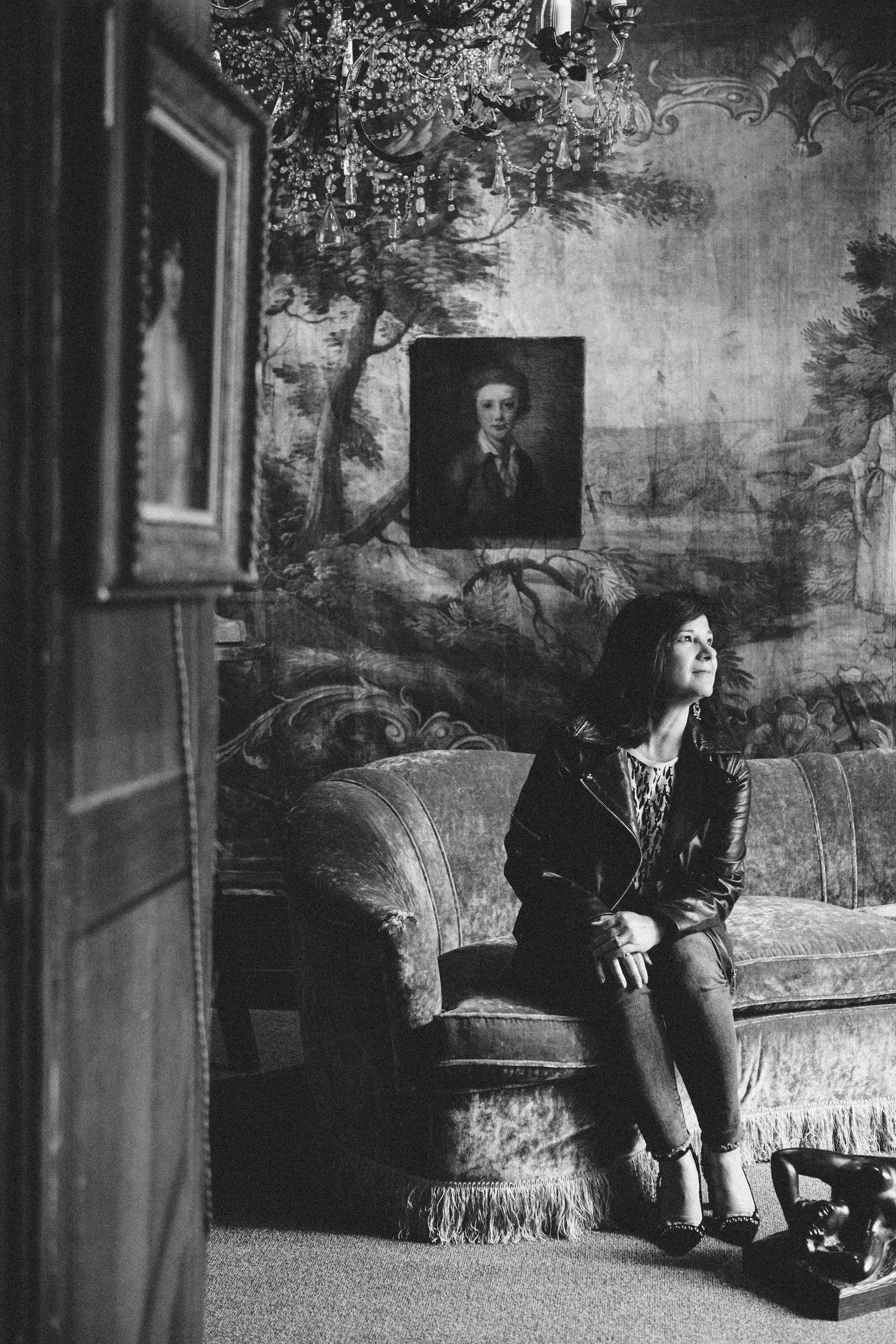 Film noir monochrome portrait of a woman in a Parisian location, evocative photography by Carla Coulson