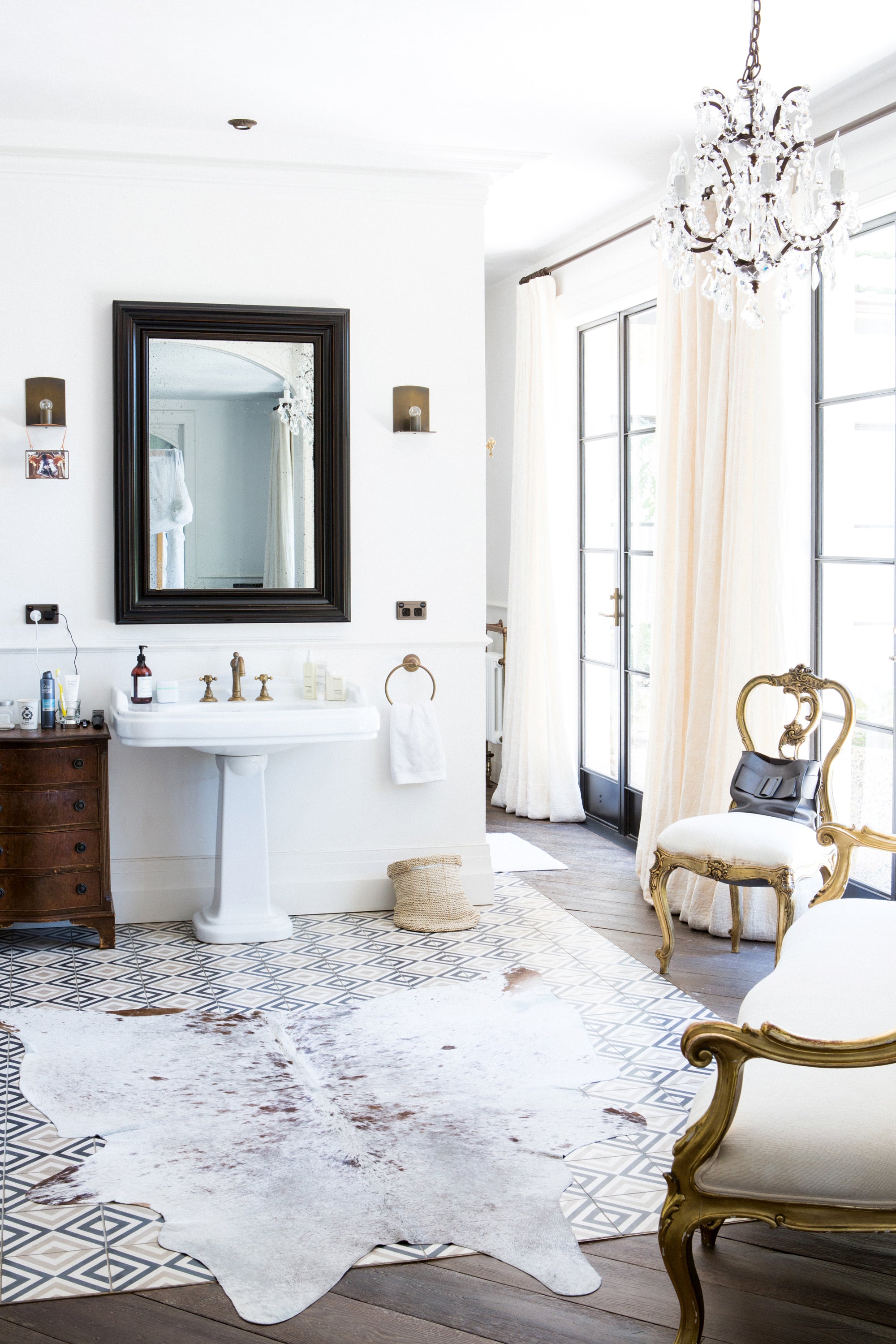 Luxurious bathroom with a large mirror interior, architectural detail of luxury property — editorial photography by Carla Coulson