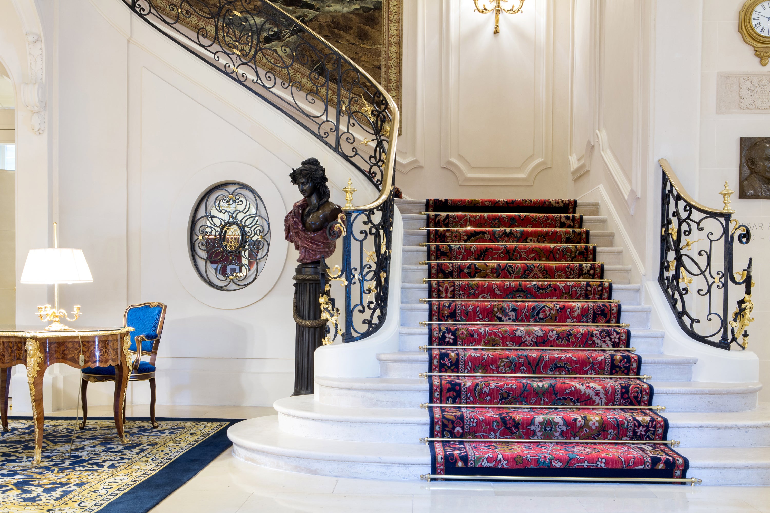Ritz Paris hotel staircase with decorative banister and floral carpet in a luxurious interior setting. — photography by Carla Coulson