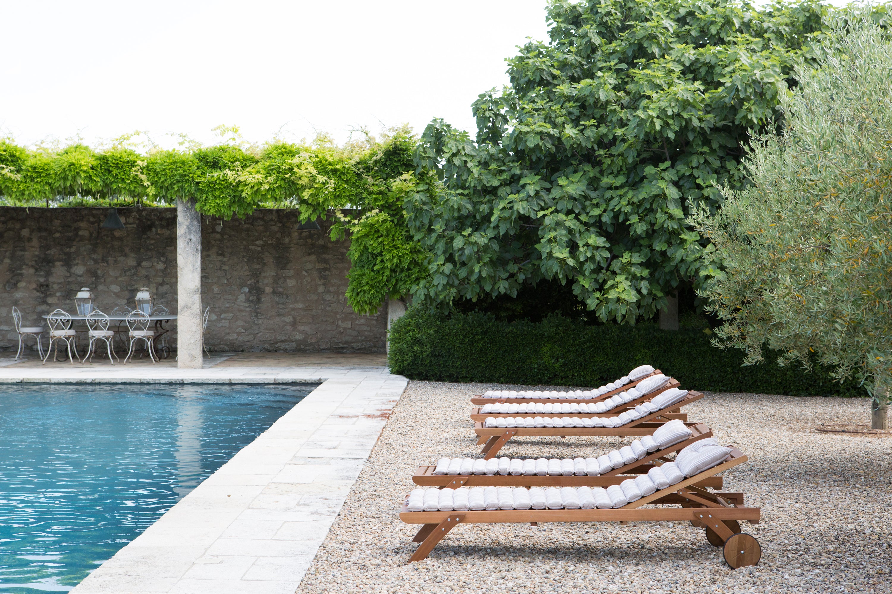 Boutique hotel poolside, serene natural light — luxury property photography by Carla Coulson