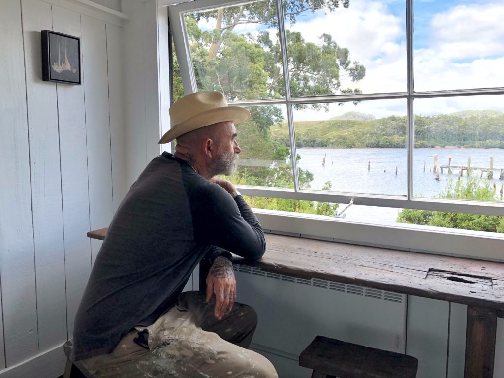 Dreams Into Reality, Artist Matthew Usmar Lauder contemplating the view at Bushy Summers Strahan Tasmania